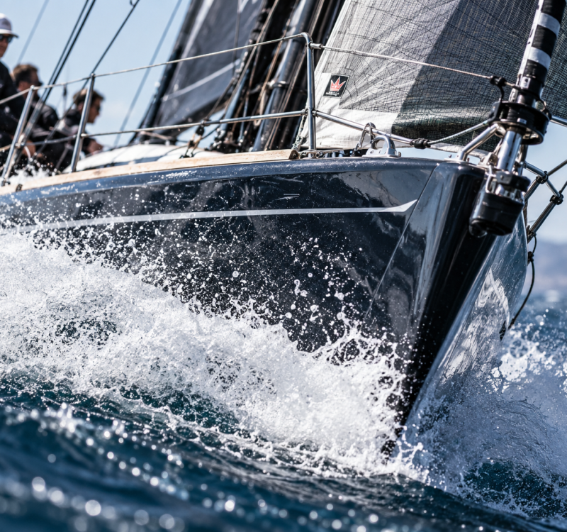 Racing sailboat splashing through waves