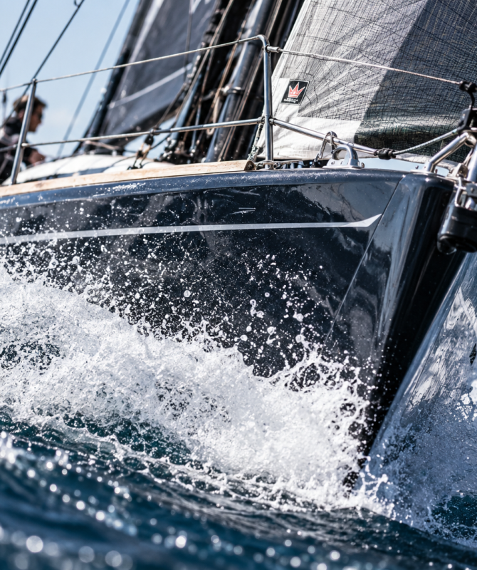 Racing sailboat splashing through waves